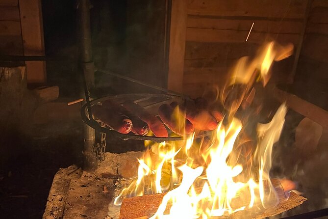 Arctic Reindeer Farm Experience with Snowshoeing in the Wild - The cabin break: campfire sausages, pastries, and actual coziness