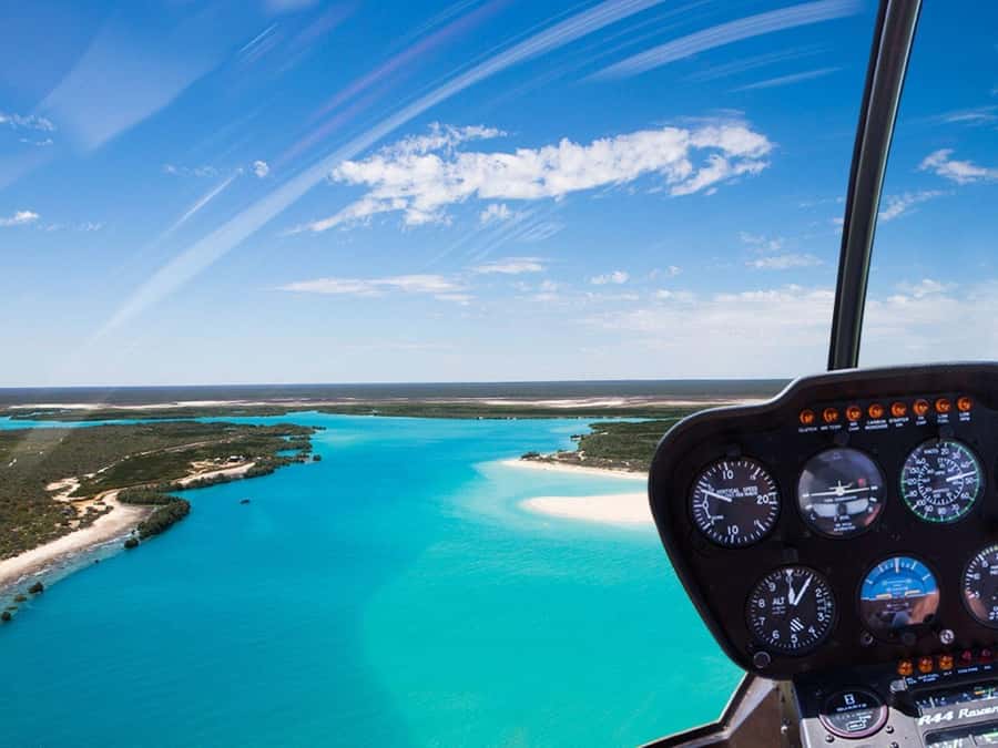 Broome: Helicopter Flight and Willie Creek Pearl Farm Tour - Return flight highlights: red cliffs, jetty views, and Roebuck Bay colors